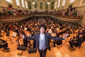 The Ulster Orchestra is celebrating 50 years as Northern Ireland?s symphony orchestra and will mark its golden anniversary with 50 pop-up performances in and around Belfast City on Wednesday 28th September. Pictured snapping a selfie with the full orchestra at the Ulster Hall ahead of the golden celebrations is Rafael Payare, Ulster Orchestra Conductor.
